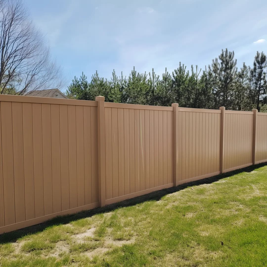 Six foot brown vinyl privacy fence installed in a Pittsburgh back yard